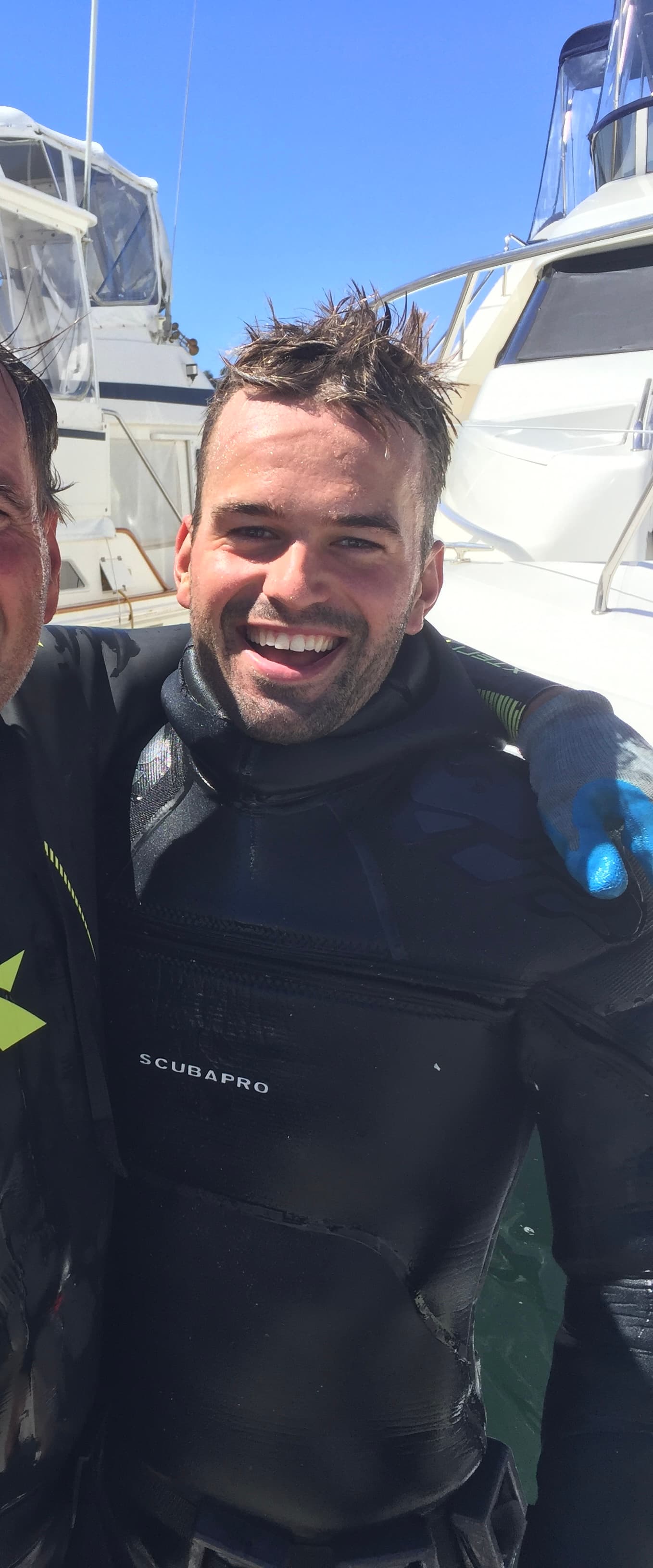 Ryan Ament after a hull cleaning dive, still in his wetsuit at the marina